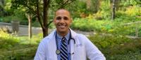 Columbia Nursing student Javier L. Aget-Torres sits on a park bench.
